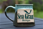 Handmade, artisan aqua and hazel ceramic mug with a stamped Michigan Sea Grant logo.