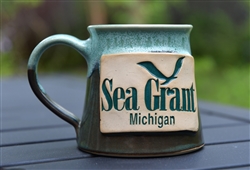 Handmade, artisan aqua and hazel ceramic mug with a stamped Michigan Sea Grant logo.