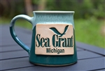 Handmade, artisan aqua and teal ceramic mug with a stamped Michigan Sea Grant logo.